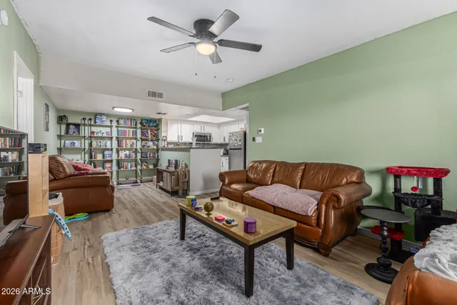 a living room with furniture a rug and a chandelier