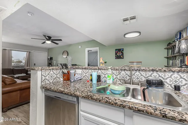 a kitchen with a sink dishwasher a stove and a refrigerator with wooden floor