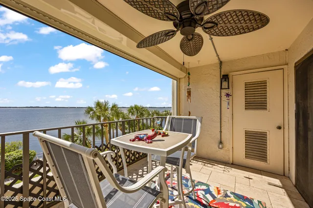 a view of a chairs and table in the balcony