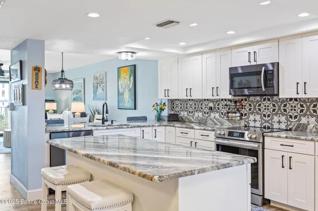 a kitchen with stainless steel appliances granite countertop a sink and cabinets