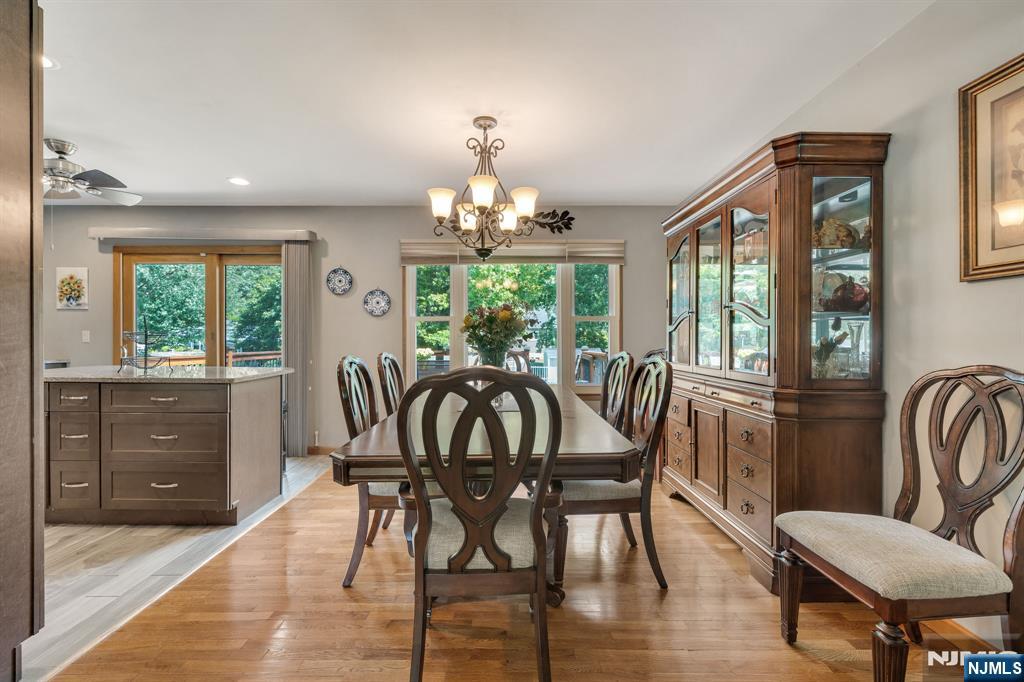 55 Marcia Road Ringwood, NJ 07456 - Photo 12 of 42 a view of a dining room with furniture a chandelier and wooden floor
