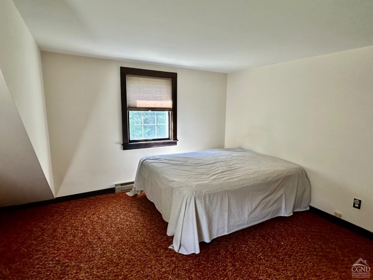 1020 Maplecrest Road East Jewett, NY 12424 - Photo 26 of 30 a bed sitting in a bedroom next to a window