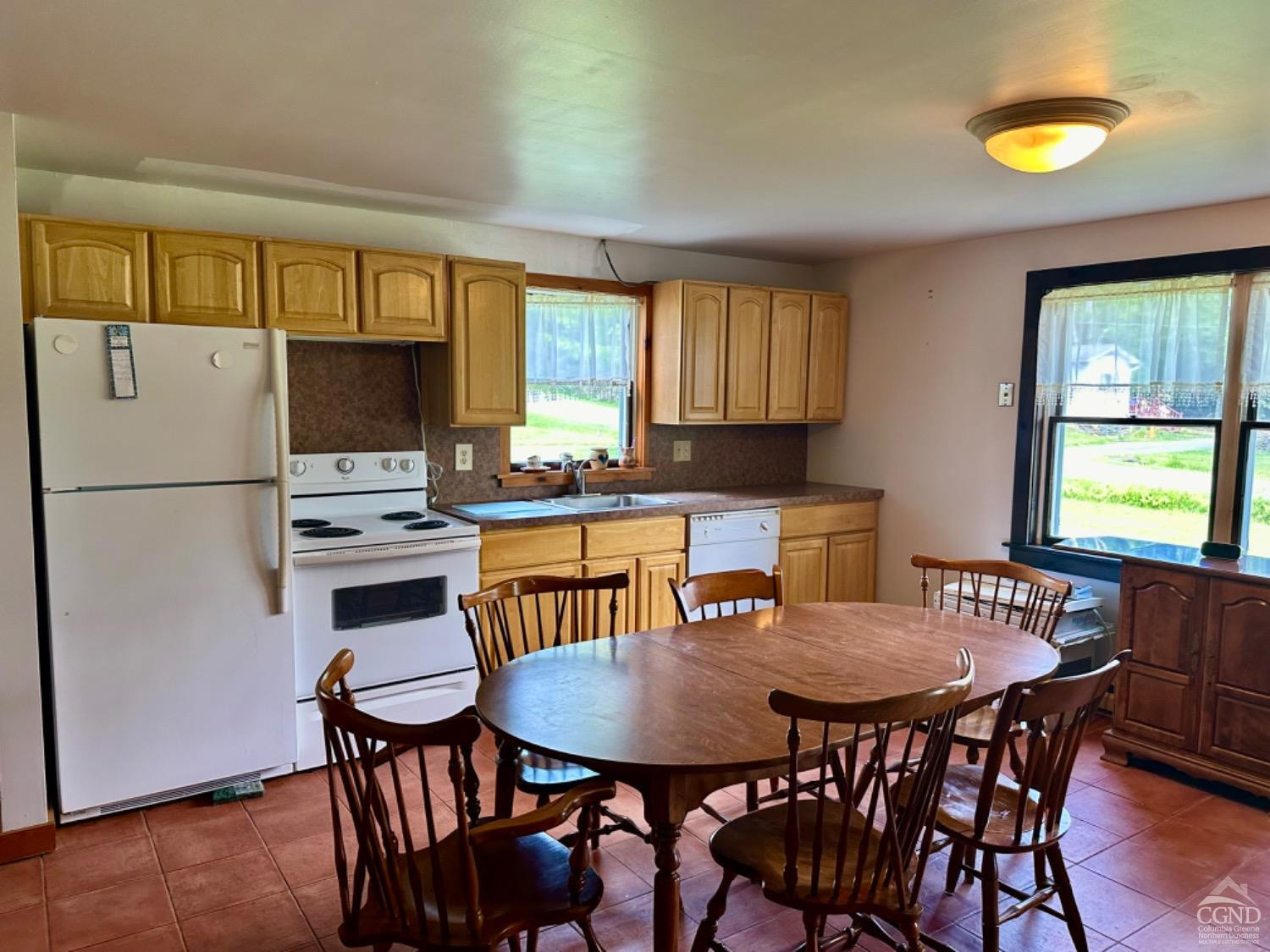 1020 Maplecrest Road East Jewett, NY 12424 - Photo 10 of 30 a kitchen with a dining table chairs and a refrigerator