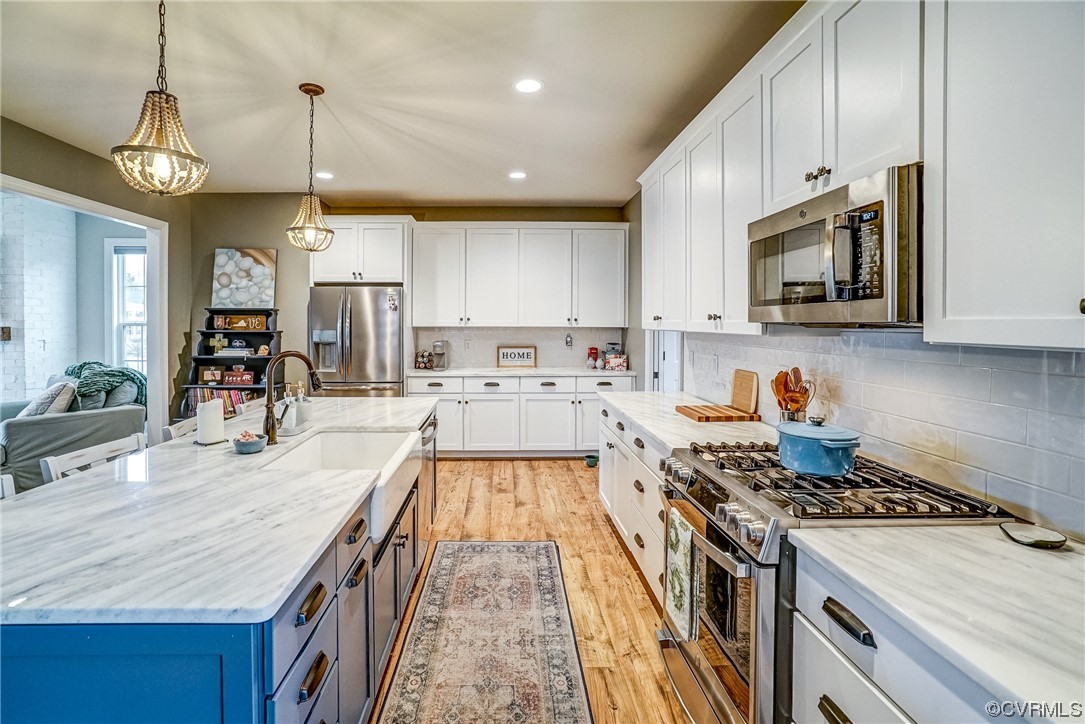 709 West Vaughan Road Ashland, VA 23005 - Photo 18 of 50 a kitchen with kitchen island a stove a sink and a microwave