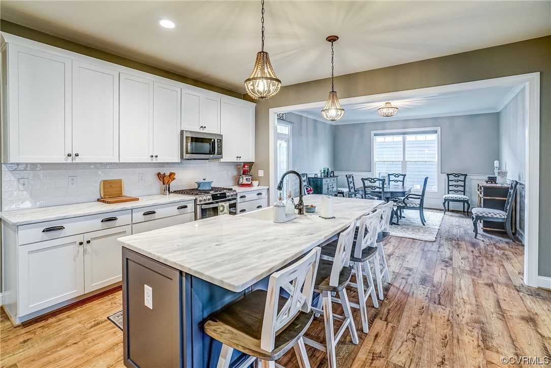 709 West Vaughan Road Ashland, VA 23005 - Photo 19 of 50 a kitchen with a dining table chairs sink and cabinets
