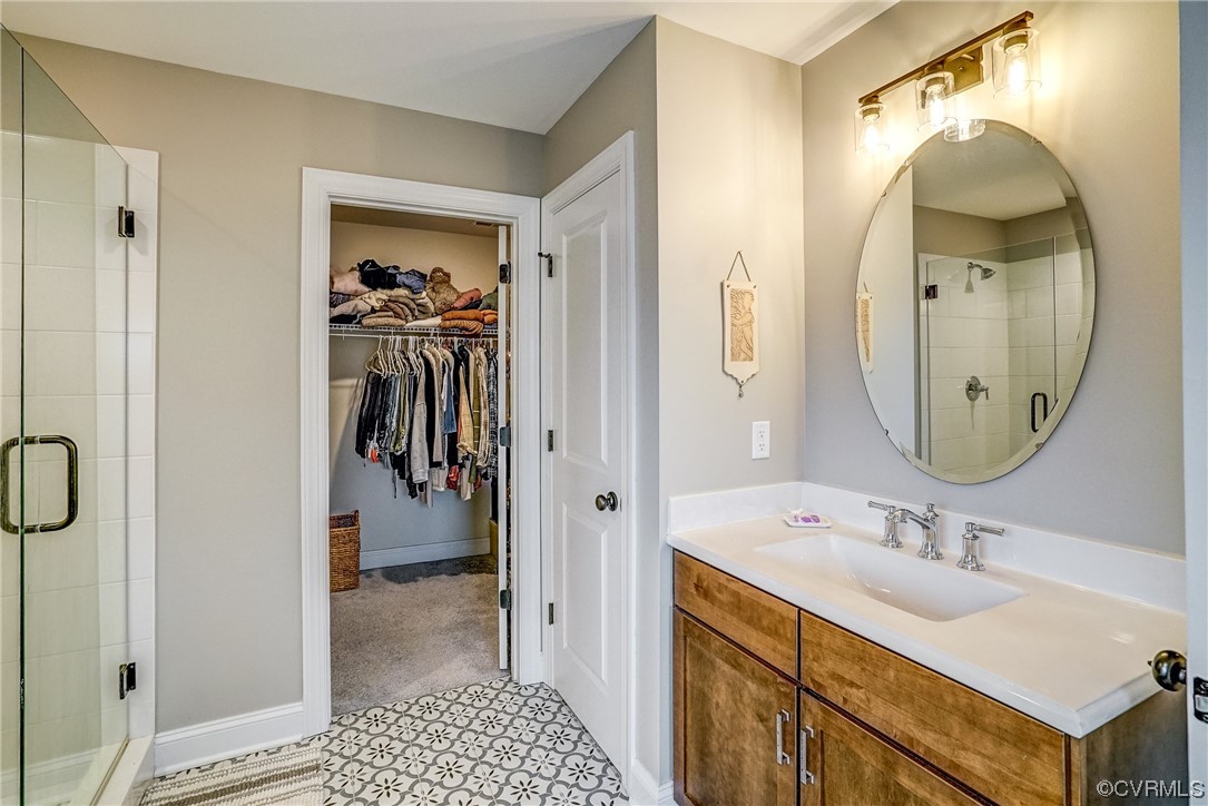 709 West Vaughan Road Ashland, VA 23005 - Photo 34 of 50 a en suite bathroom with a granite countertop sink and a mirror