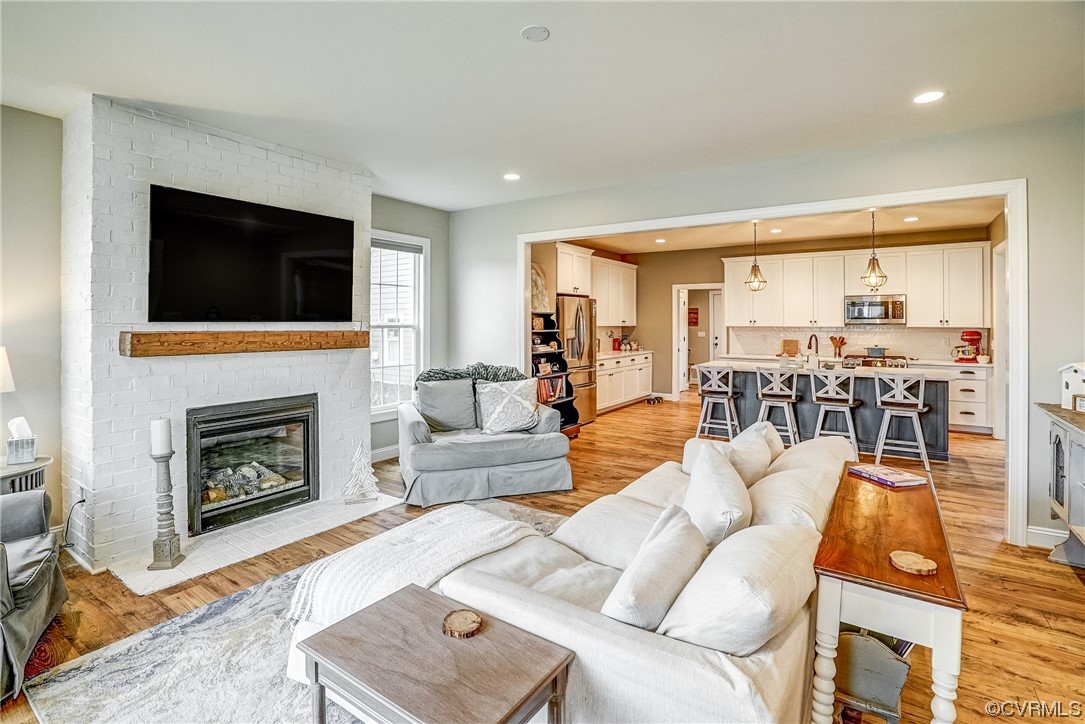 709 West Vaughan Road Ashland, VA 23005 - Photo 10 of 50 a living room with furniture a fireplace and a flat screen tv