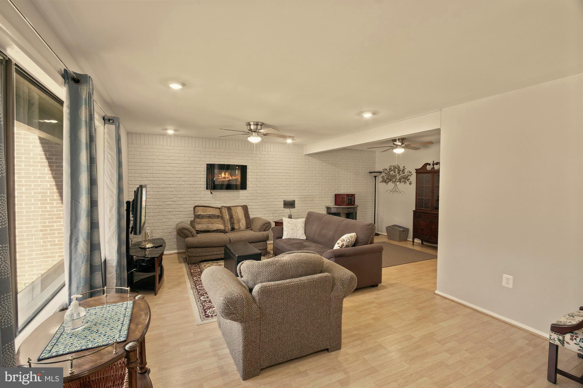 9122 Centerway Road Gaithersburg, MD 20879 - Photo 7 of 33 a living room with furniture and a flat screen tv