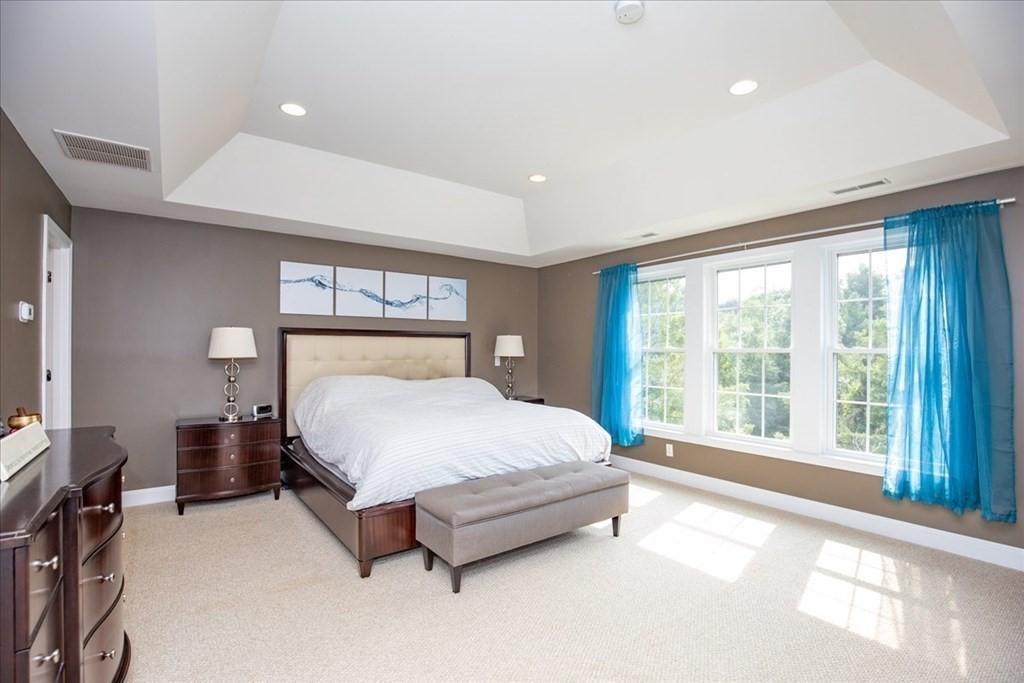11 Sparrow Lane Danvers, MA 01923 - Photo 23 of 41 a bed sitting in a spacious bedroom next to a window