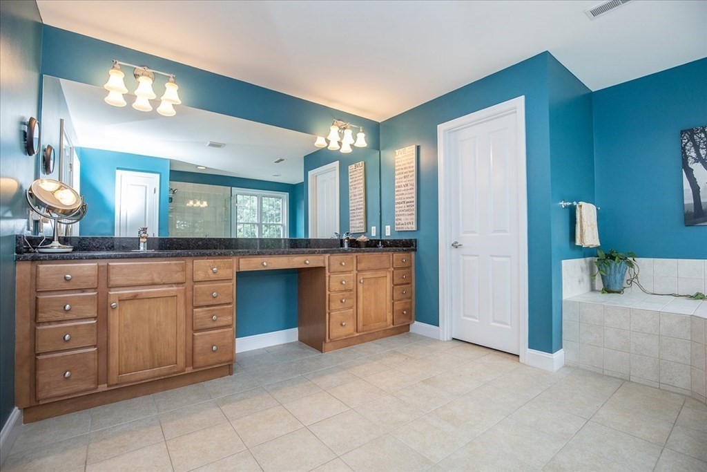 11 Sparrow Lane Danvers, MA 01923 - Photo 25 of 41 a spacious bathroom with a granite countertop sink and a mirror