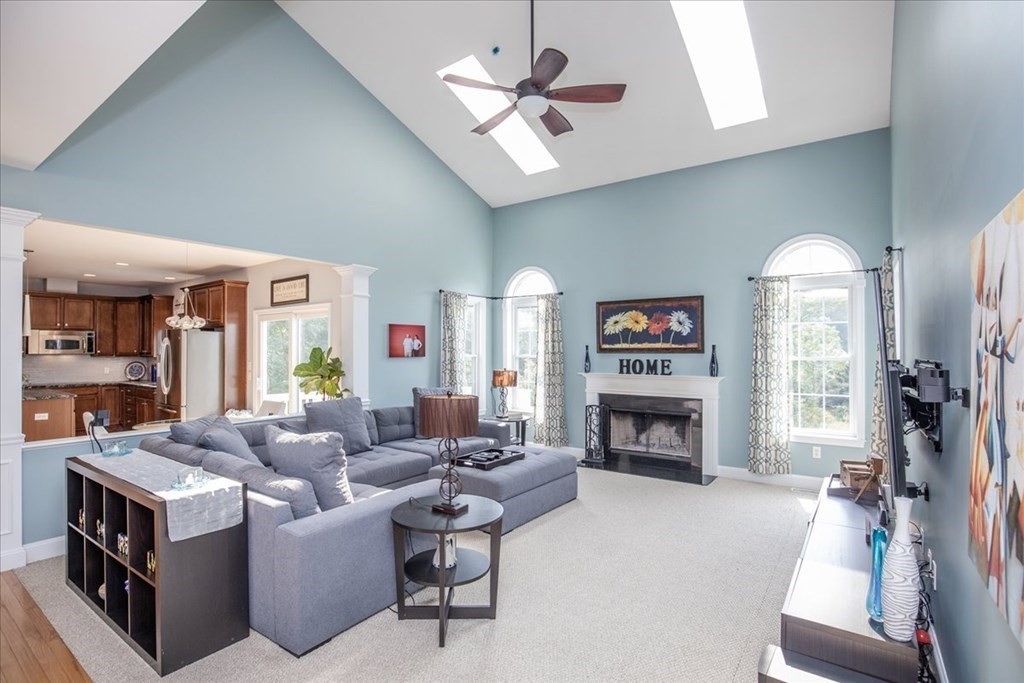 11 Sparrow Lane Danvers, MA 01923 - Photo 3 of 41 a living room with furniture a fireplace and a flat screen tv