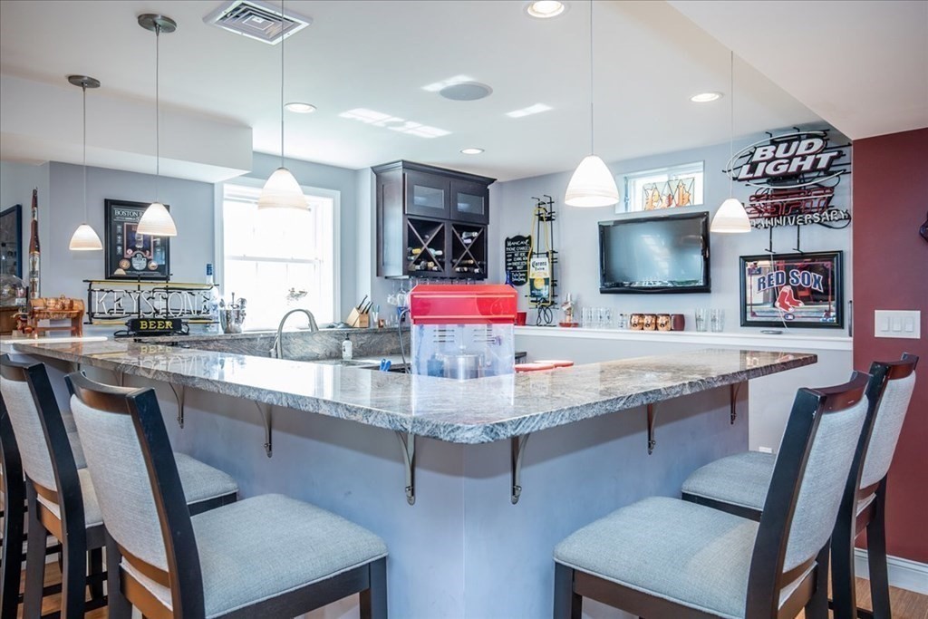 11 Sparrow Lane Danvers, MA 01923 - Photo 33 of 41 a kitchen with a table chairs refrigerator and microwave