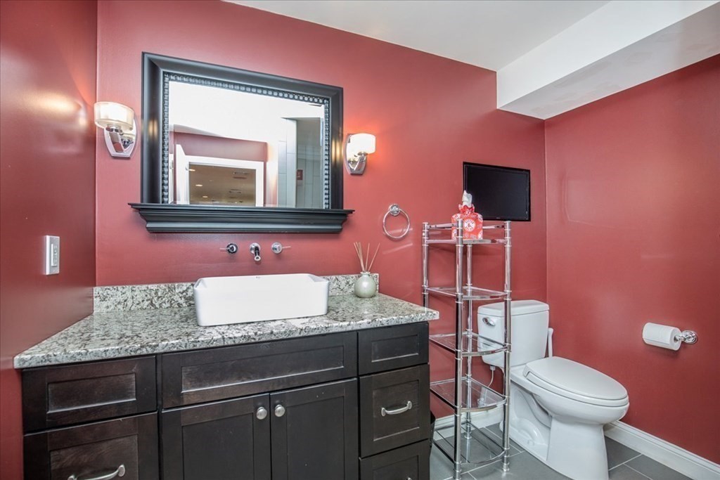 11 Sparrow Lane Danvers, MA 01923 - Photo 36 of 41 a bathroom with a granite countertop toilet sink and mirror