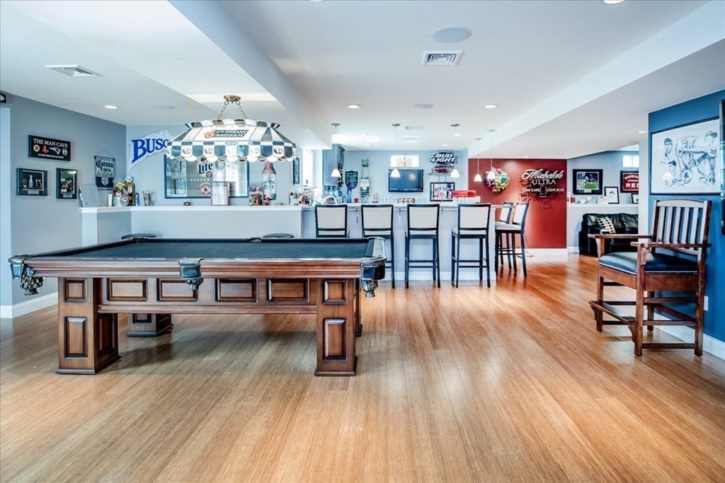 11 Sparrow Lane Danvers, MA 01923 - Photo 5 of 41 a living room with furniture a wooden floor and a book shelf