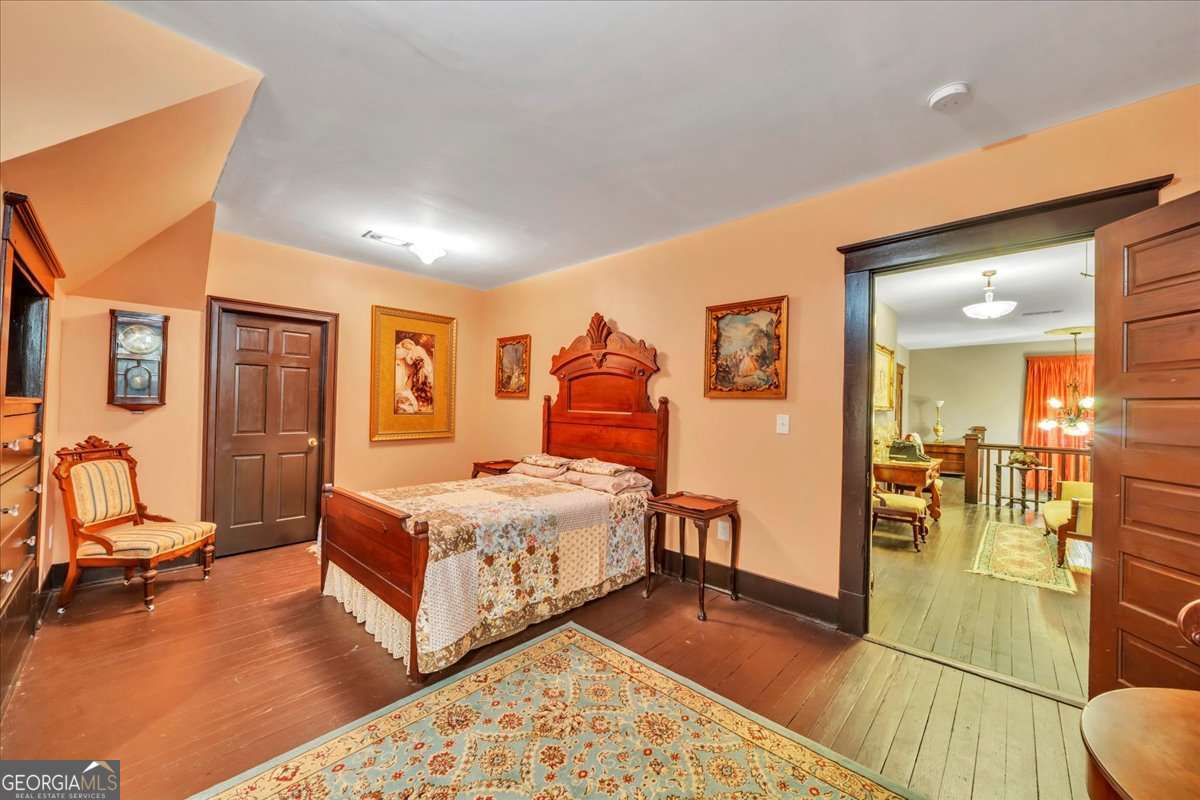 212 East Union Street Vienna, GA 31092 - Photo 39 of 62 a bedroom with a bed and wooden floor