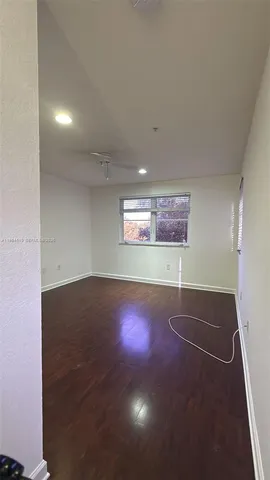 an empty room with a space and windows