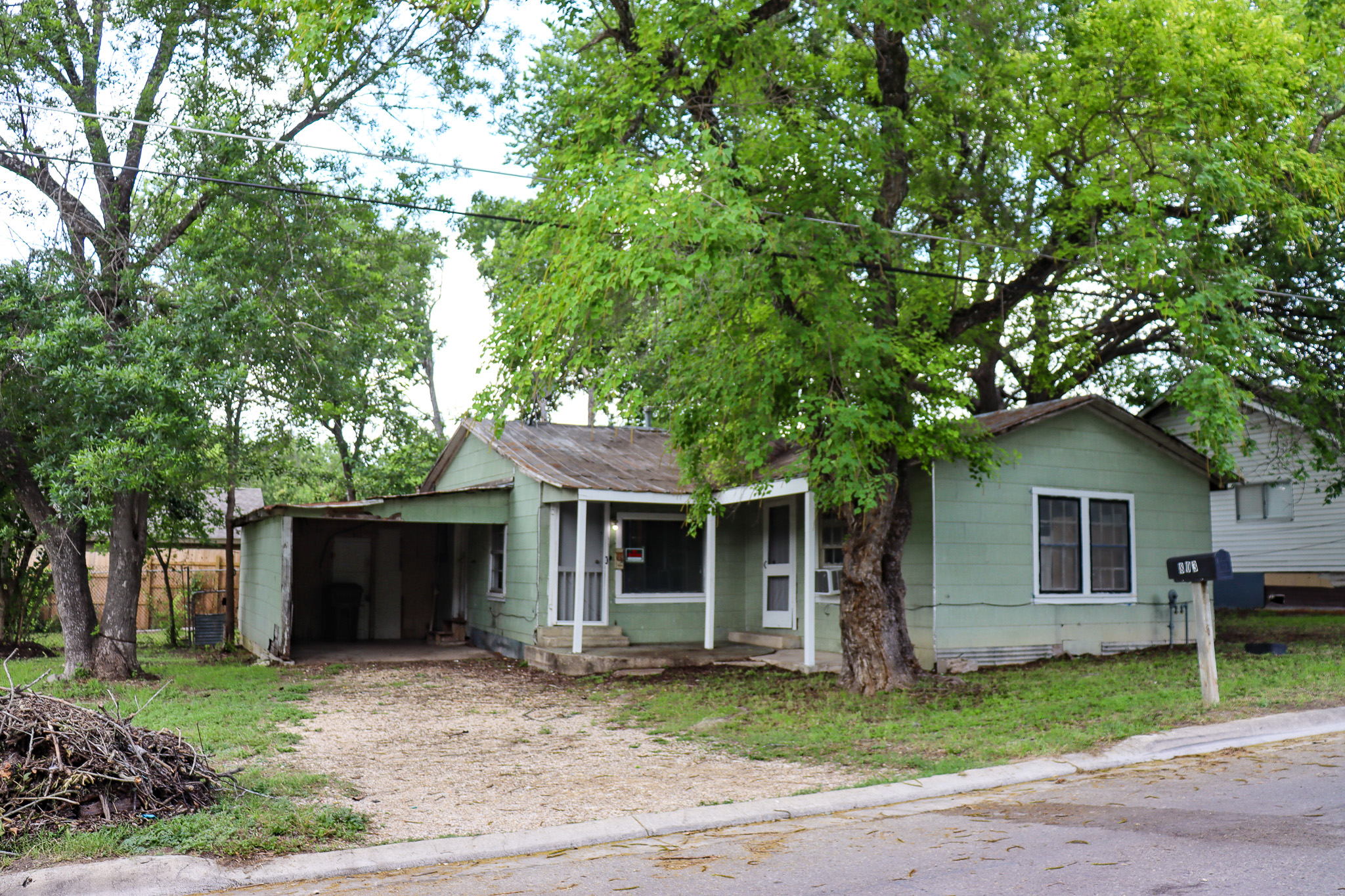 803 3rd Street Lockhart, TX 78644 - Photo 2 of 15 a front view of a house with a garden and tree