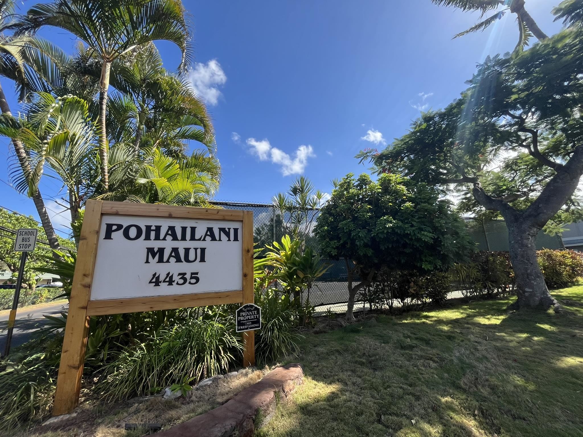 4435 Lower Honoapiilani Road, Unit 225 Lahaina, HI 96761 - Photo 28 of 35 a sign that is sitting in the grass with tree in the background
