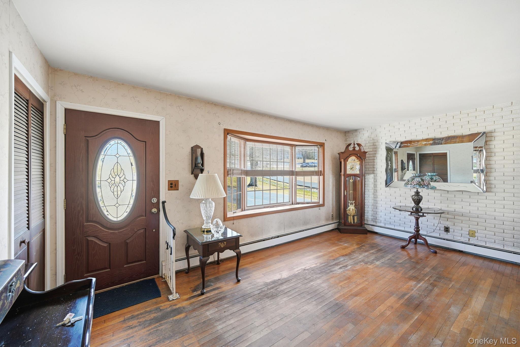 50 Everett Road Carmel, NY 10512 - Photo 2 of 23 an empty room with mirror a furniture and a window