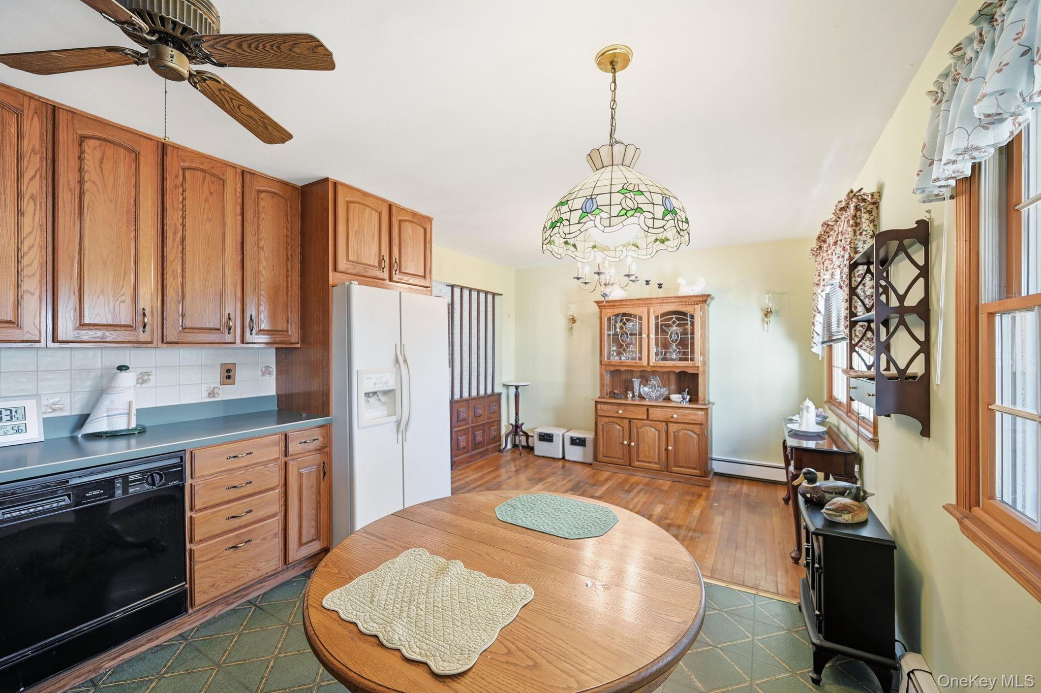 50 Everett Road Carmel, NY 10512 - Photo 6 of 23 a kitchen with stainless steel appliances granite countertop a stove a sink dishwasher and a refrigerator with wooden floor
