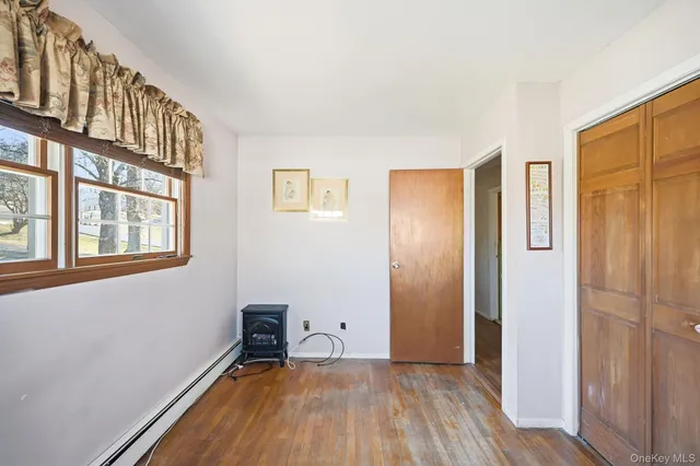 a view of a livingroom with an empty space and a window