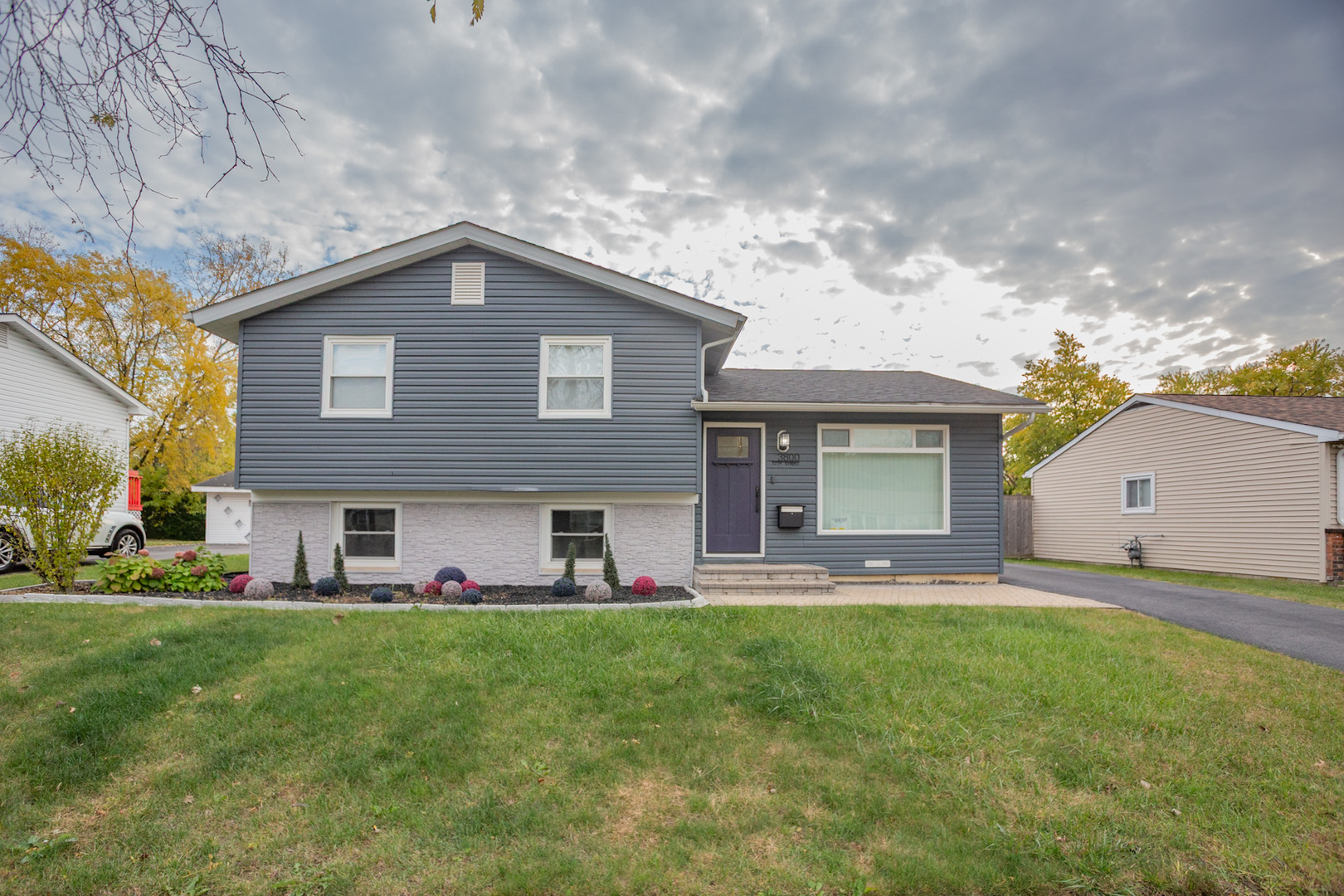 a front view of house with yard and green space