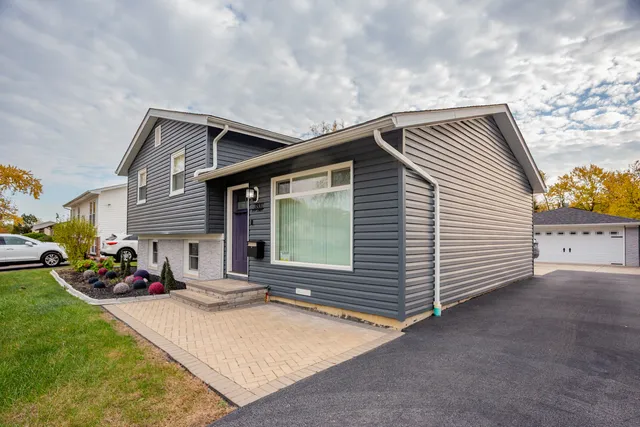 a backyard of a house with table and chairs