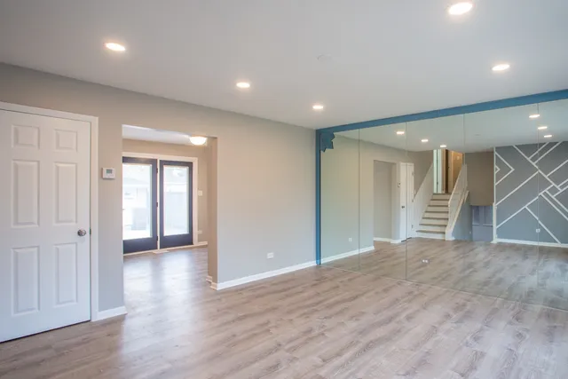 a view of livingroom with an empty space and wooden floor