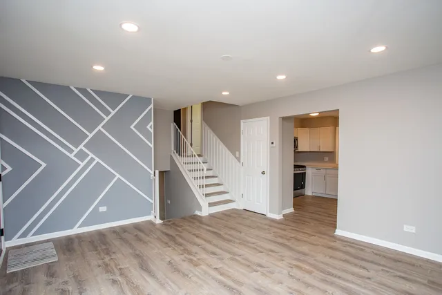 a view of entryway and hall with wooden floor