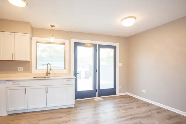 a view of a kitchen with a sink cabinets and wooden floor