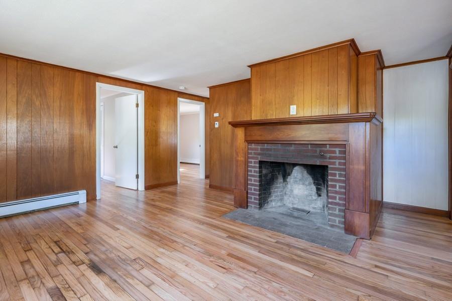 343 Strawberry Hill Road Centerville, MA 02632 - Photo 3 of 15 a view of an empty room with wooden floor and a fireplace