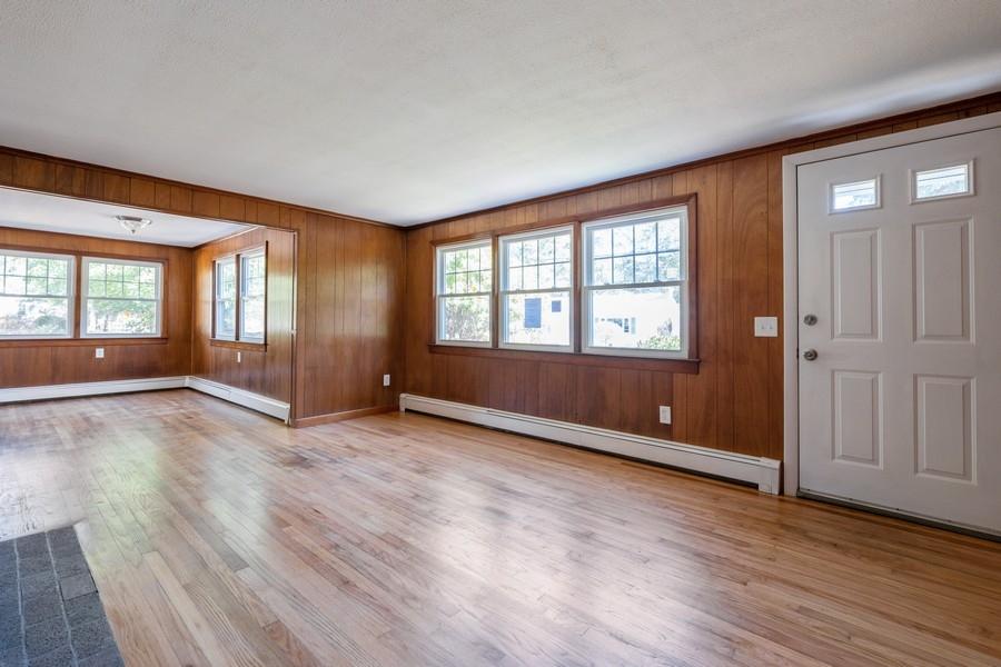 343 Strawberry Hill Road Centerville, MA 02632 - Photo 4 of 15 an empty room with wooden floor and windows