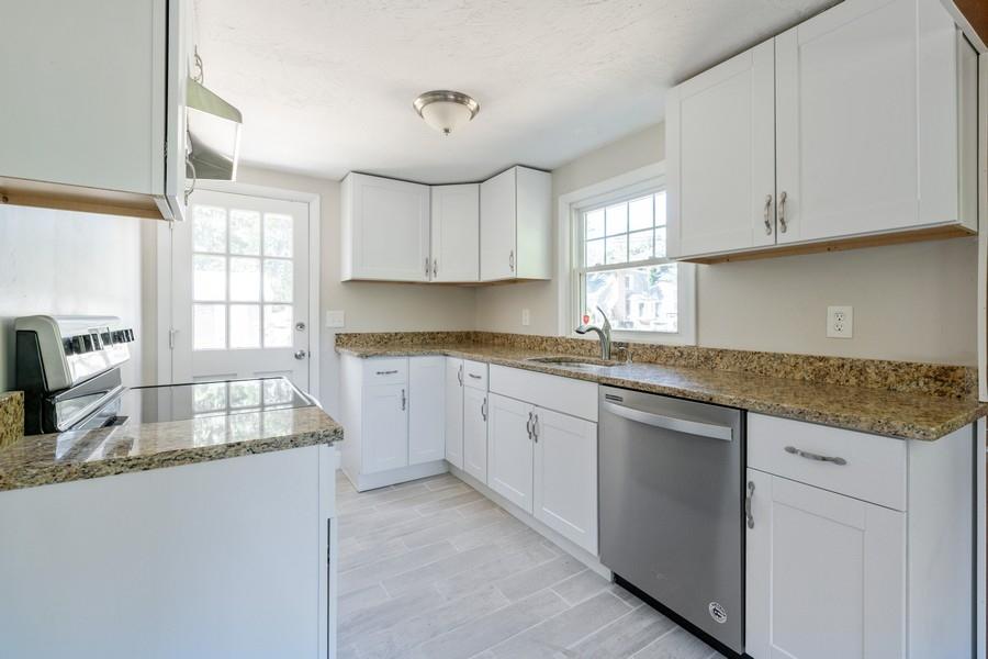 343 Strawberry Hill Road Centerville, MA 02632 - Photo 6 of 15 a kitchen with granite countertop a sink window and cabinets