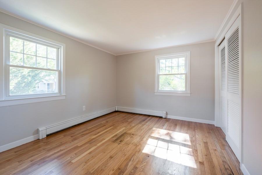 343 Strawberry Hill Road Centerville, MA 02632 - Photo 8 of 15 an empty room with wooden floor and windows
