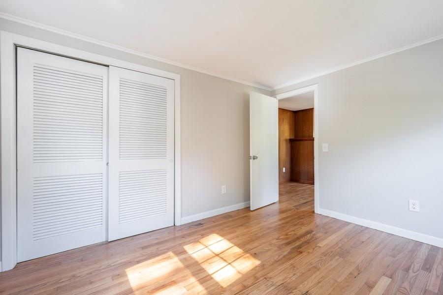 343 Strawberry Hill Road Centerville, MA 02632 - Photo 9 of 15 an empty room with wooden floor and windows