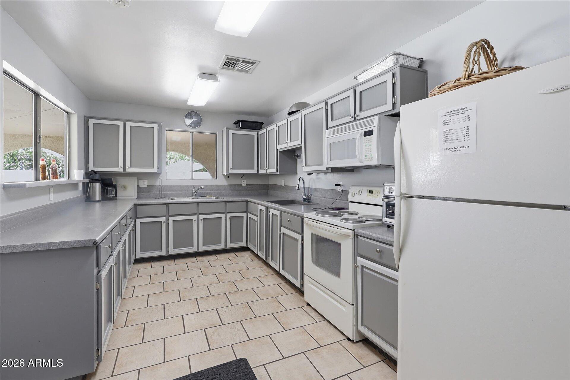 3270 South Goldfield Road, Unit 716 Apache Junction, AZ 85119 - Photo 27 of 36 a kitchen with stainless steel appliances a sink cabinets and a counter top space