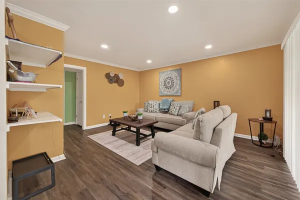 a living room with furniture and a wooden floor