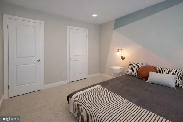 a bedroom with a bed and a night stand