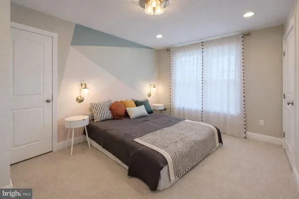 a spacious bedroom with a bed and a chandelier
