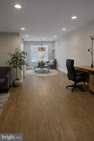 a view of a workspace with furniture and a potted plant