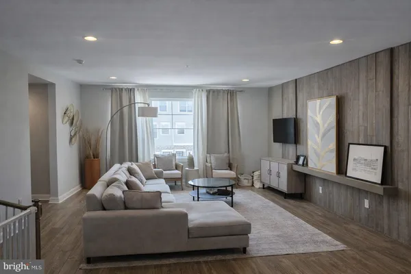 a living room with furniture windows and a flat screen tv