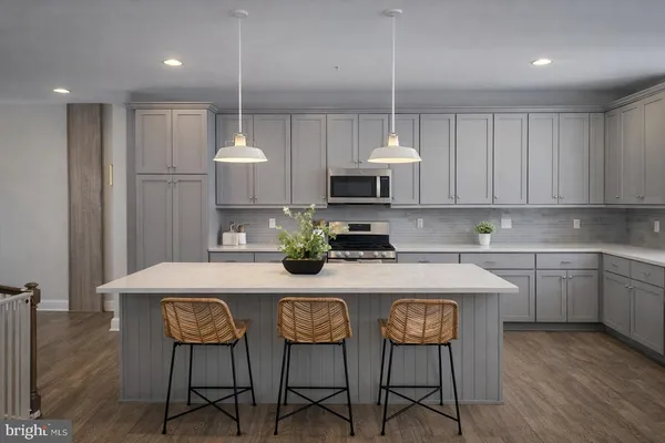 a kitchen with kitchen island granite countertop a table and chairs in it