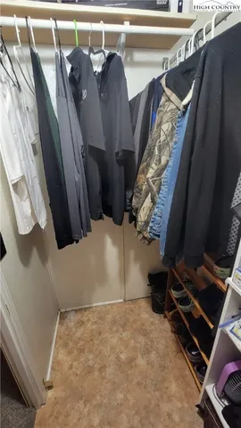 a view of walk in closet with clothes and shoes