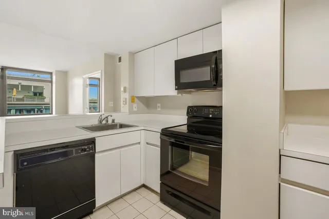 a kitchen with a sink dishwasher and a refrigerator