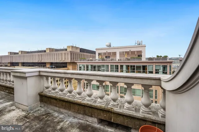 a balcony with a table and chairs