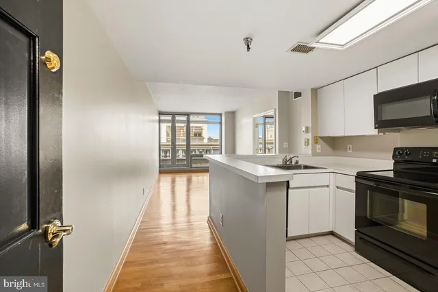 a kitchen with a sink and steel appliances