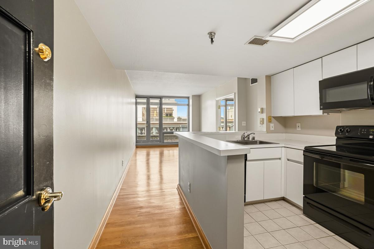 801 Pennsylvania Avenue Northwest, Unit PH06 Washington, DC 20004 - Photo 10 of 38 a kitchen with a sink and steel appliances