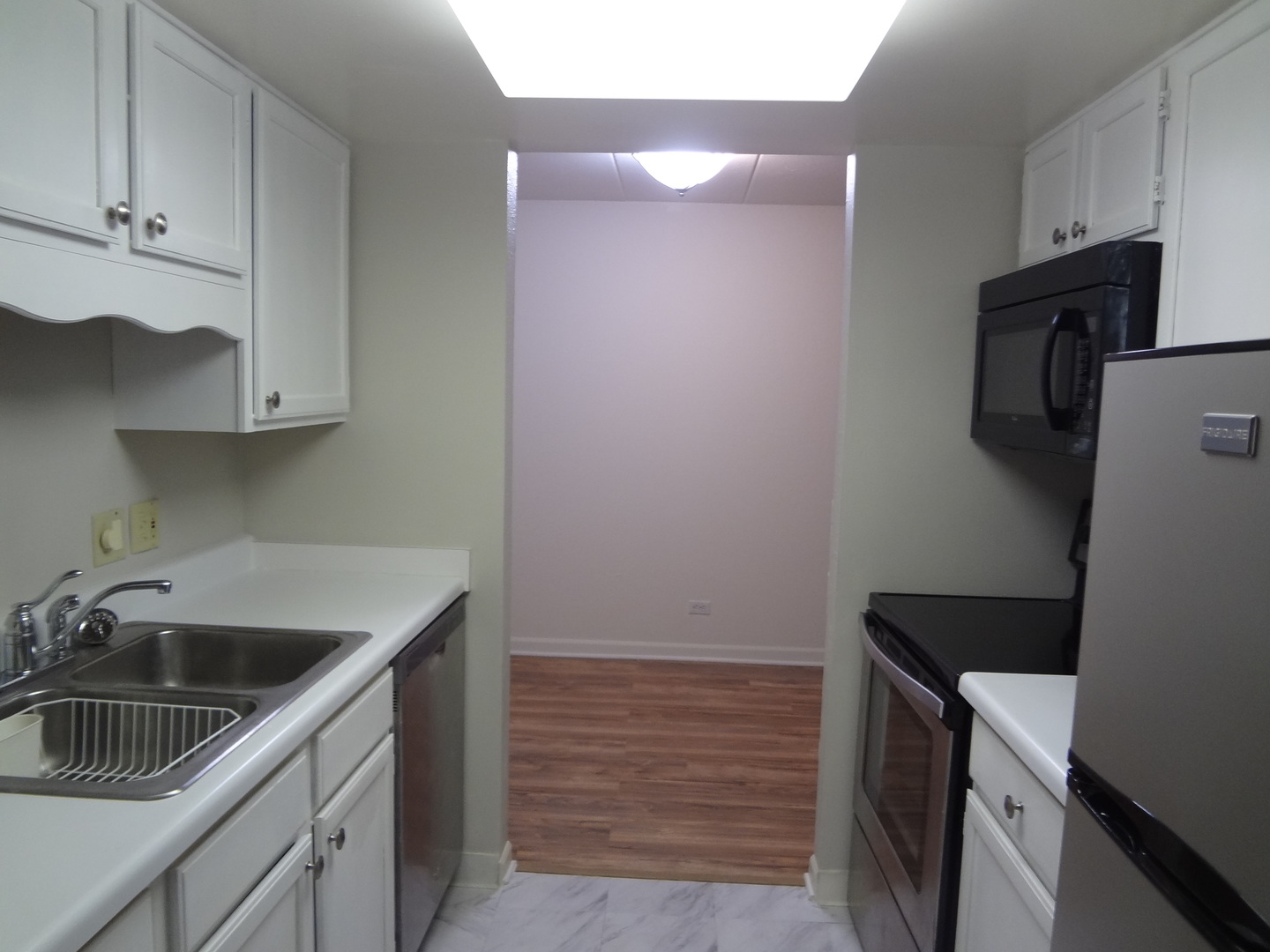 1 Renaissance Place, Unit 905 Palatine, IL 60067 - Photo 7 of 21 a kitchen with a sink and a refrigerator