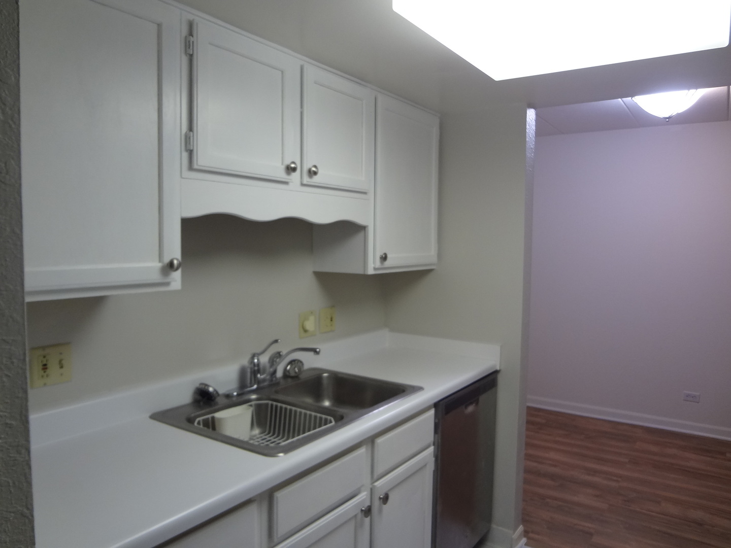 1 Renaissance Place, Unit 905 Palatine, IL 60067 - Photo 8 of 21 a kitchen with sink cabinets and wooden floor