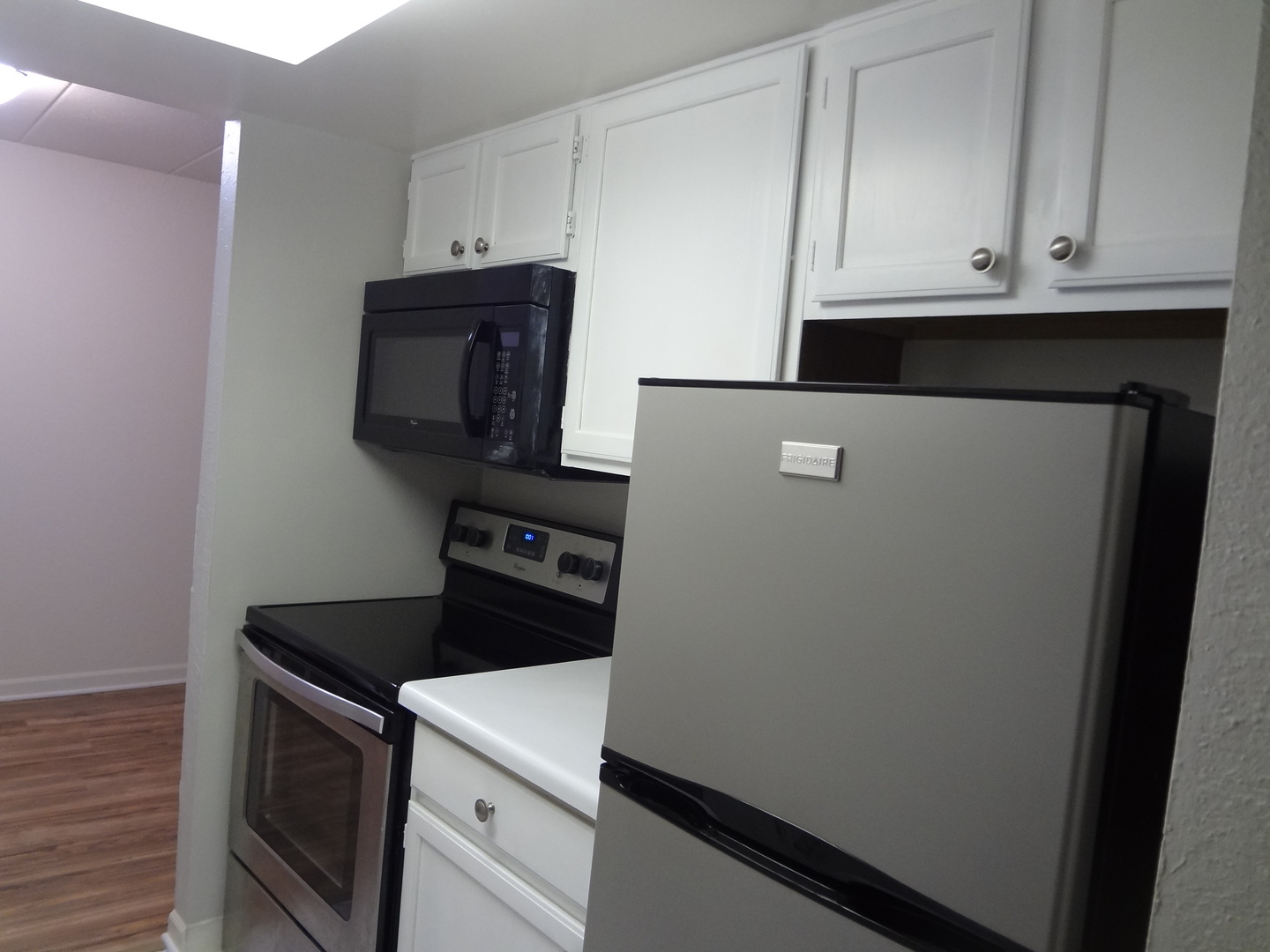 1 Renaissance Place, Unit 905 Palatine, IL 60067 - Photo 9 of 21 a kitchen with white cabinets and black appliances